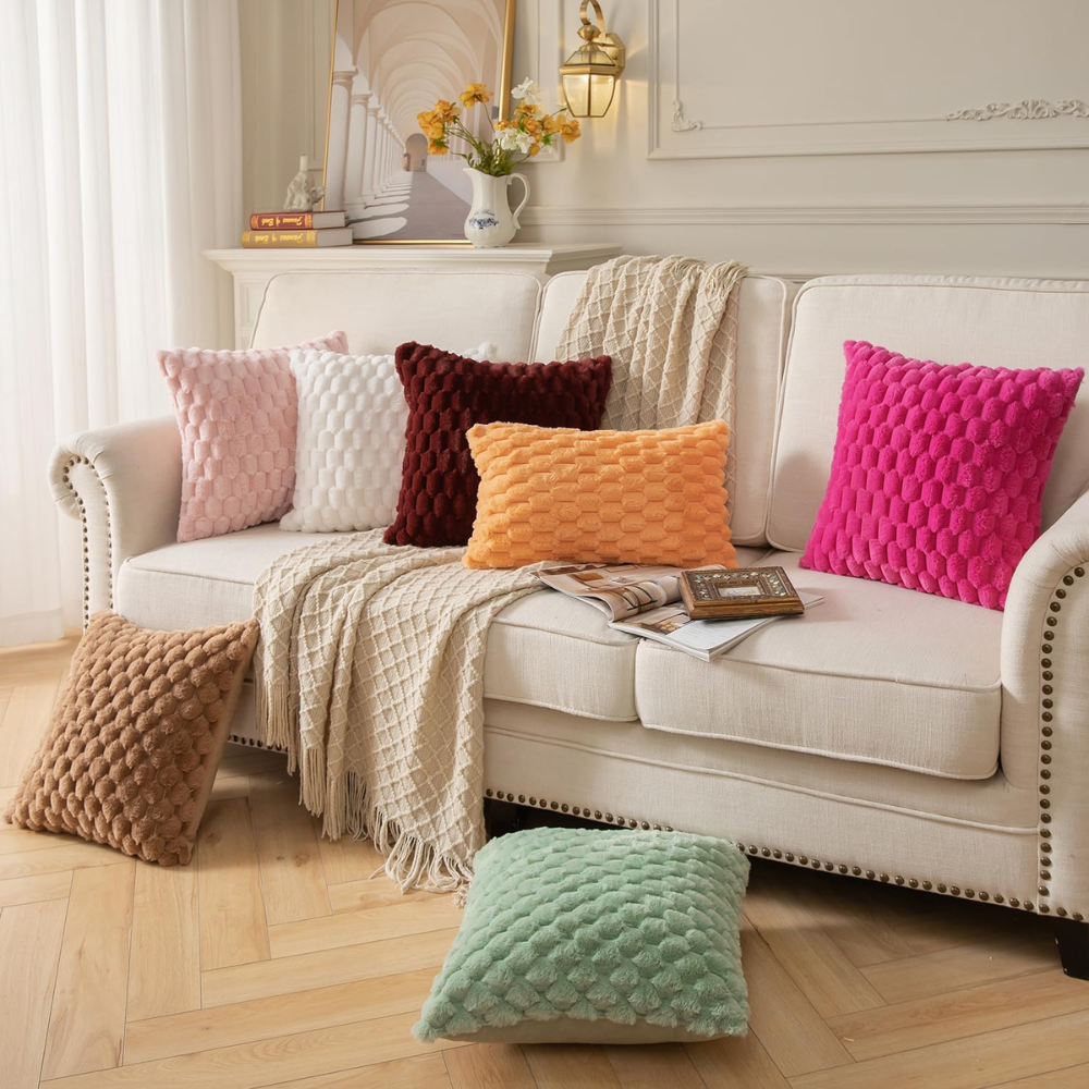 Housses de coussin à bulles de plusieurs coloris sur un canapé blanc dans un salon lumineux