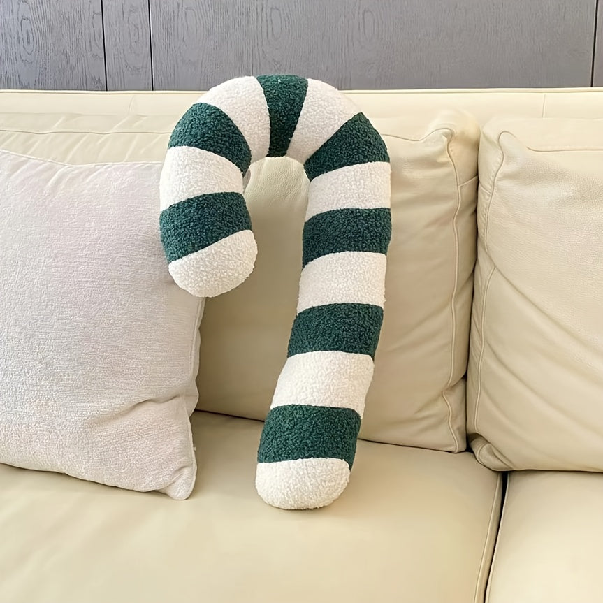 Coussin sucre d'orge vert sur un canapé clair