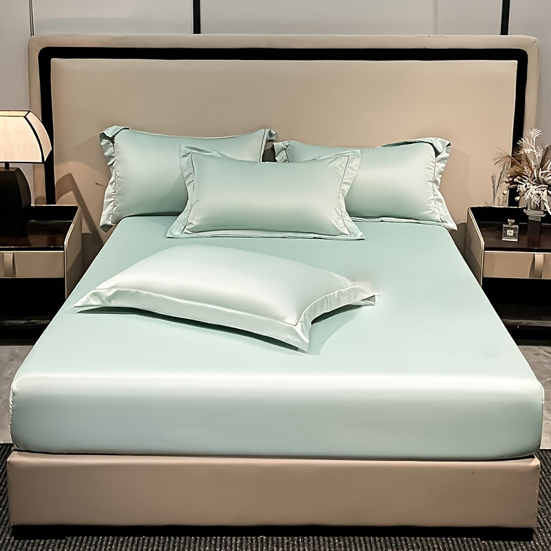 Drap-housse aspect satiné vert menthe sur un lit double